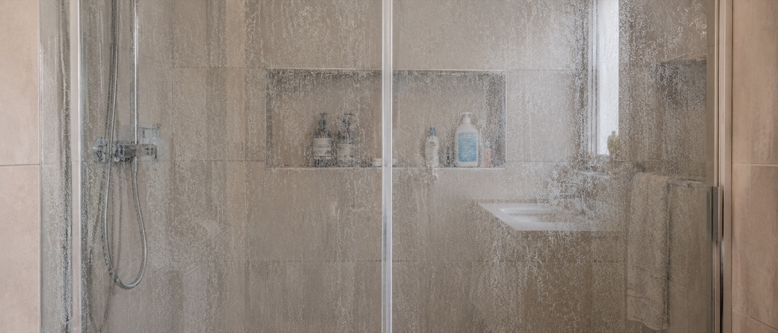 Mampara de ducha cubierta de cal tras años de uso
